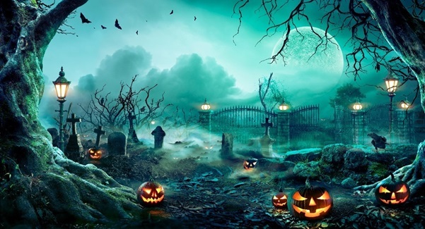 Spooky halloween image showing glowing jack-o-lanterns, graveyard, full moon, and crows flying