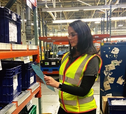 Female warehouse worker wearing safety vest