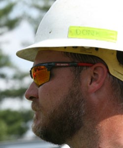 MCR Safety worker with glasses and hard hat