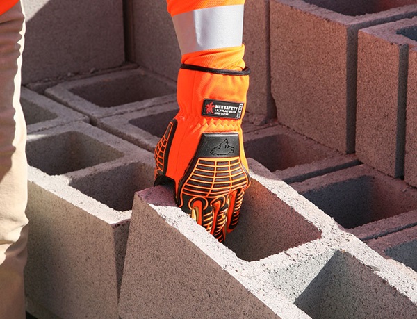 MCR Safety Hi-Vis Glove Picking up Concrete block
